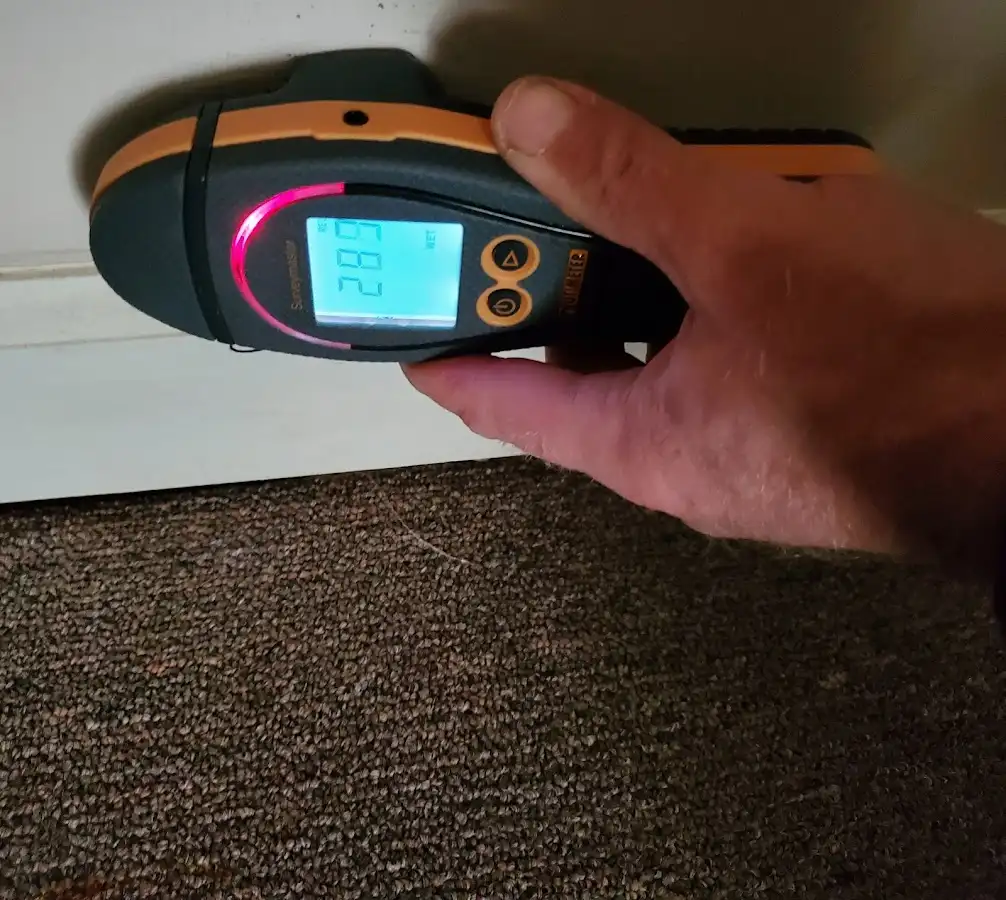 Moisture detection at baseboard during Storm Damage Restoration in Maltby